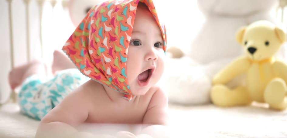 Oasis Dental Studio - When Do Babies Start Teething? | Symptoms & Remedies - 3 laying-baby