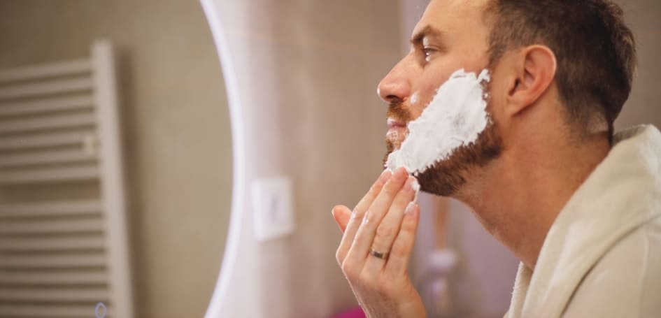 man-shaving-at-mirror